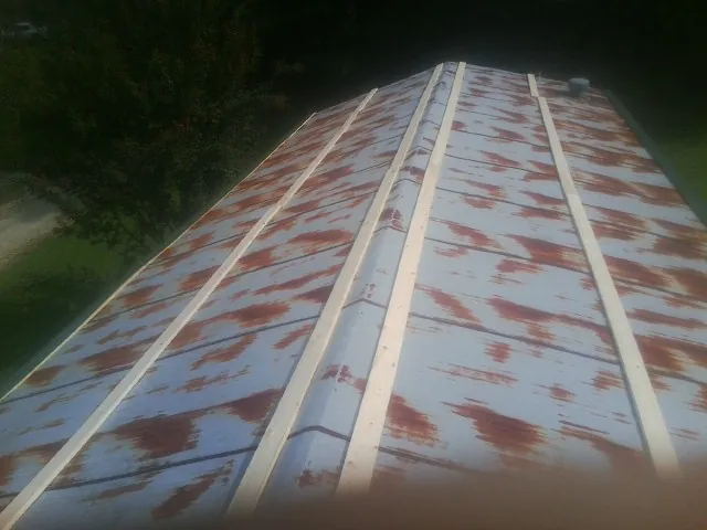 Rusted metal roof panels with new wood purlins before replacement — Storm Damage Roof Repair in Hackensack by Roofing Brothers